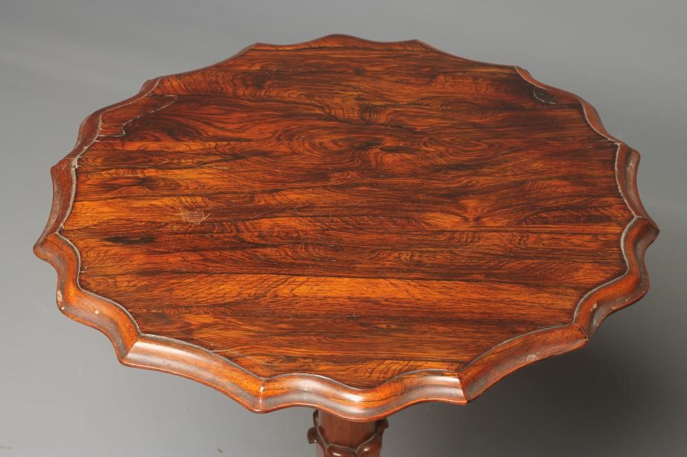 A VICTORIAN ROSEWOOD LAMP TABLE of circular form with moulded wavy edged top Image