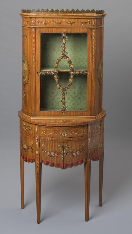 AN EDWARDIAN SATINWOOD TWO STAGE DISPLAY CABINET of demi lune form painted with floral festoons and Image