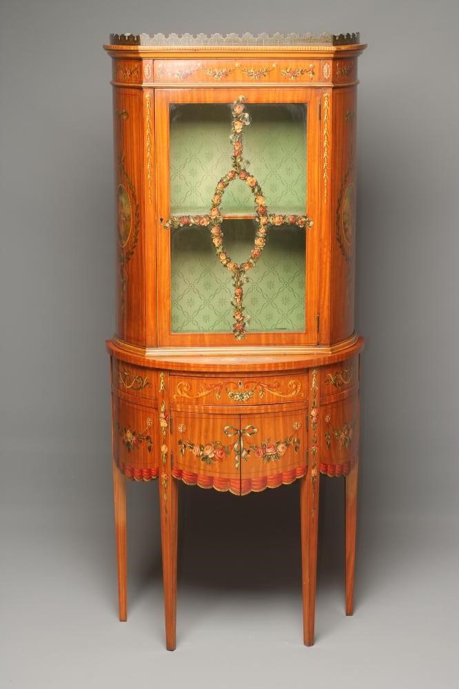 AN EDWARDIAN SATINWOOD TWO STAGE DISPLAY CABINET of demi lune form painted with floral festoons and Image