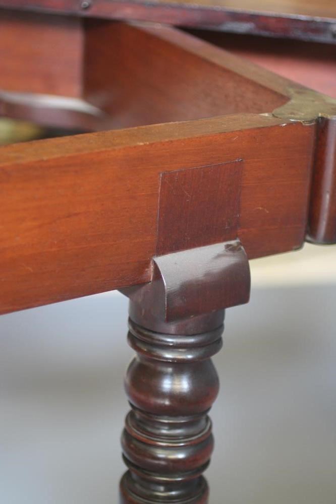 A FINE QUALITY REGENCY MAHOGANY EXTENDING DINING TABLE of rounded oblong form with ebony stringing Image