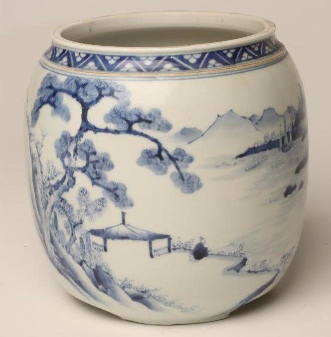 A JAPANESE PORCELAIN JAR AND COVER of cylindrical form raised upon three bracket feet Image
