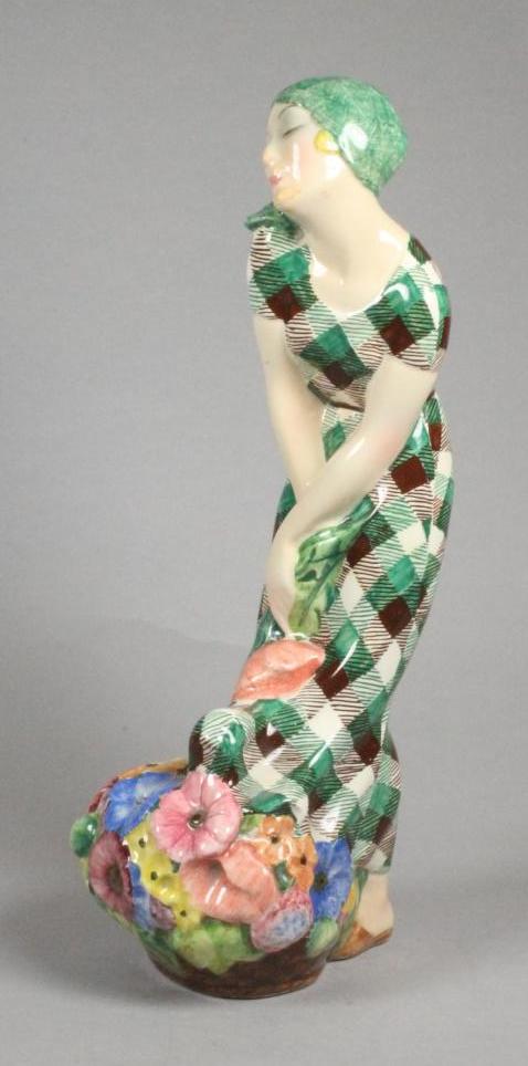AN ART DECO IGNI OF TORINO EARTHENWARE FIGURE OF A YOUNG FLOWER SELLER wearing a green headscarf and Image
