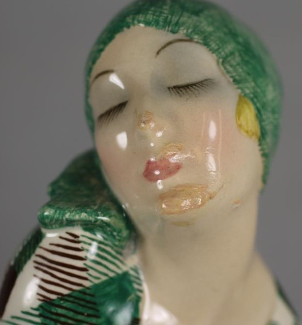 AN ART DECO IGNI OF TORINO EARTHENWARE FIGURE OF A YOUNG FLOWER SELLER wearing a green headscarf and Image