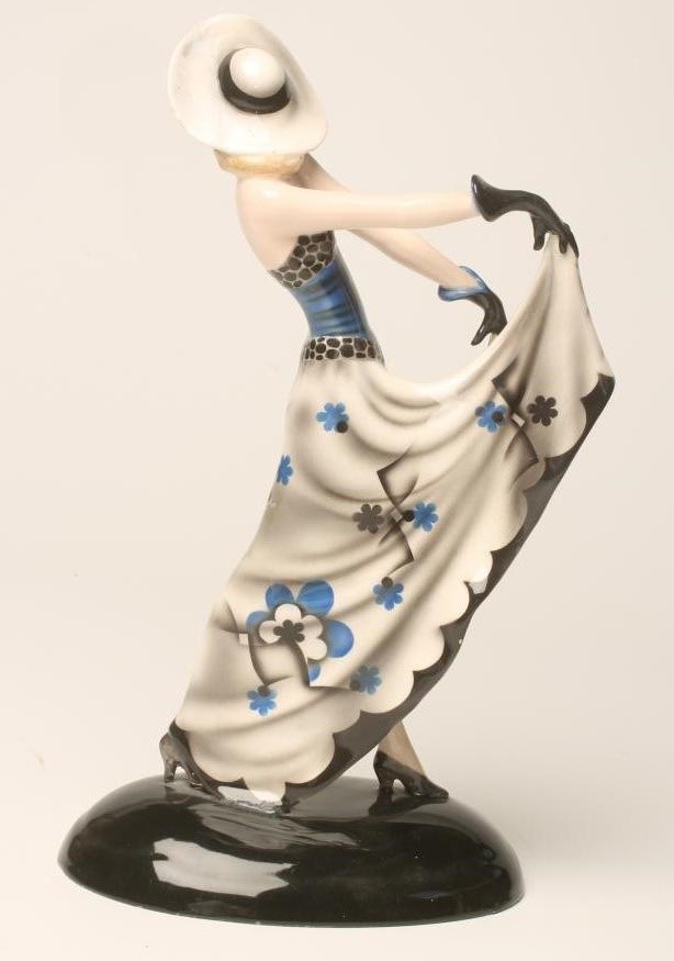 AN ART DECO DAKON GOLDSCHEIDER EARTHENWARE FIGURE of a young lady wearing a wide brimmed hat Image