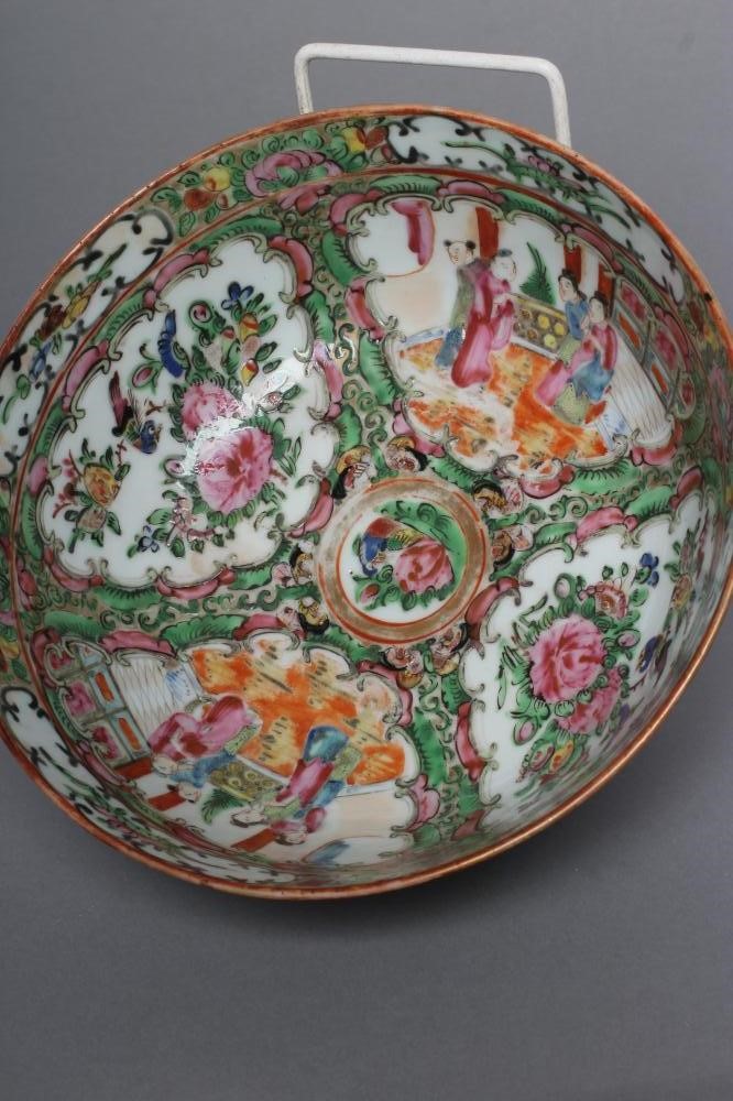 A CANTONESE PORCELAIN FAMILLE ROSE BOWL painted with panels of figures on verandahs and with finches Image