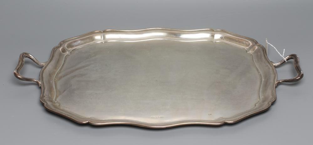 A TWO HANDLED TEA TRAY, maker's mark HA, Sheffield 1920, of shaped oblong form with pie-crust rim, Image