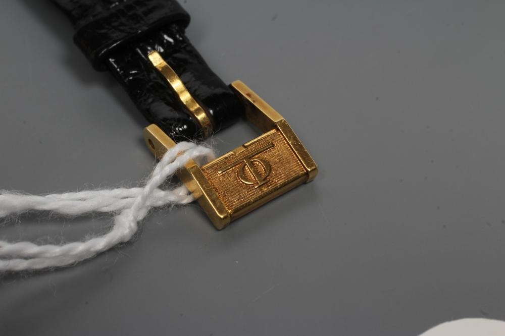 A LADY'S 18CT GOLD BAUME & MERCIER WRISTWATCH with plain dark champagne dial Image