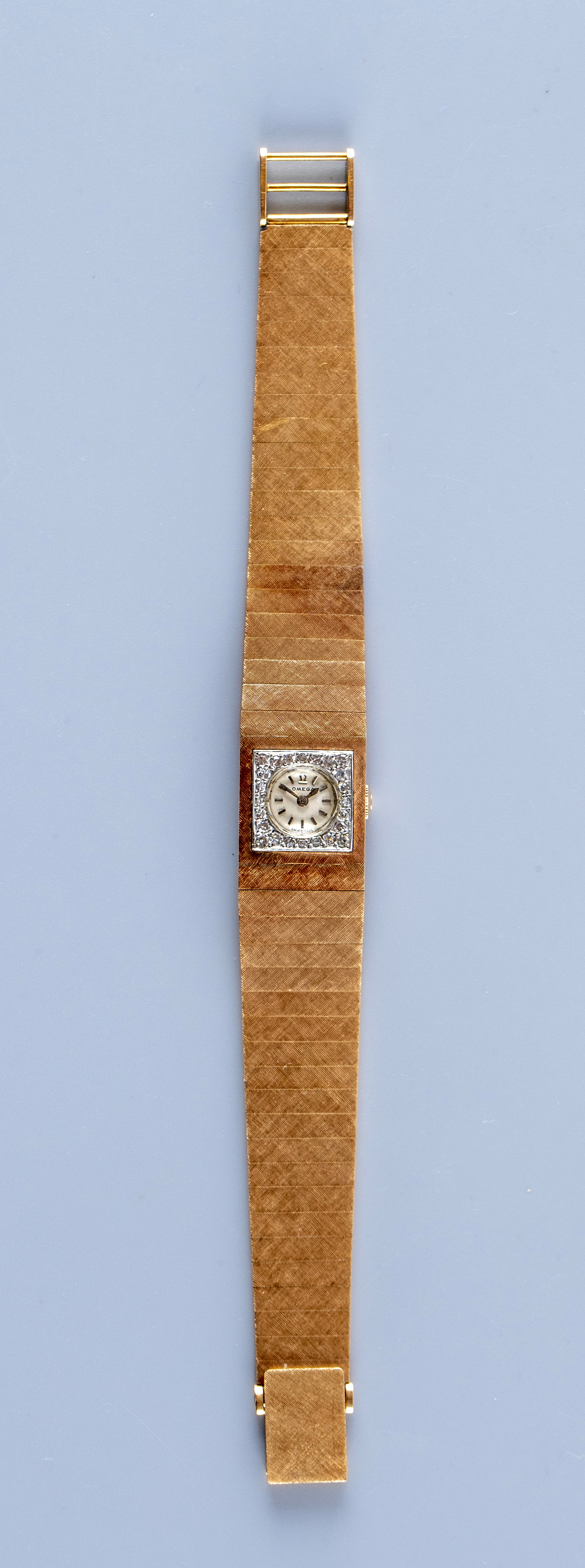 A LADY'S 18CT GOLD AND DIAMOND OMEGA WRISTWATCH Image
