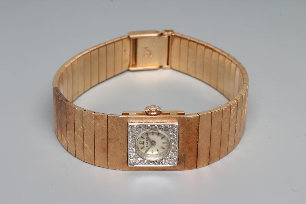 A LADY'S 18CT GOLD AND DIAMOND OMEGA WRISTWATCH Image