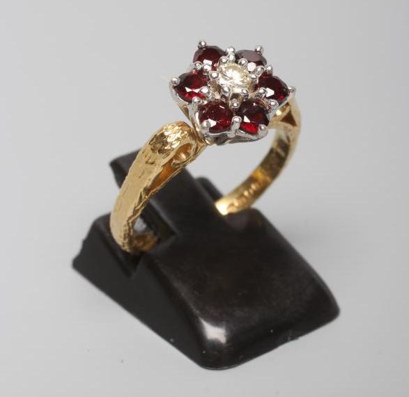 A GARNET AND DIAMOND CLUSTER RING Image