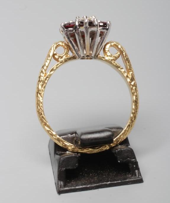 A GARNET AND DIAMOND CLUSTER RING Image