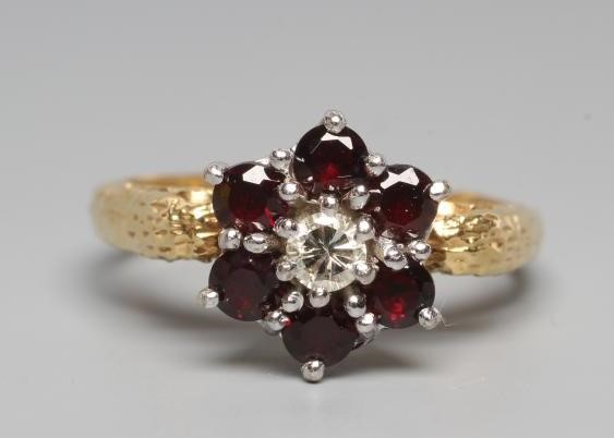 A GARNET AND DIAMOND CLUSTER RING Image