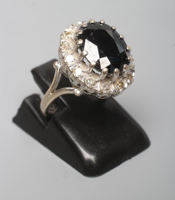A SAPPHIRE AND DIAMOND CLUSTER RING Image