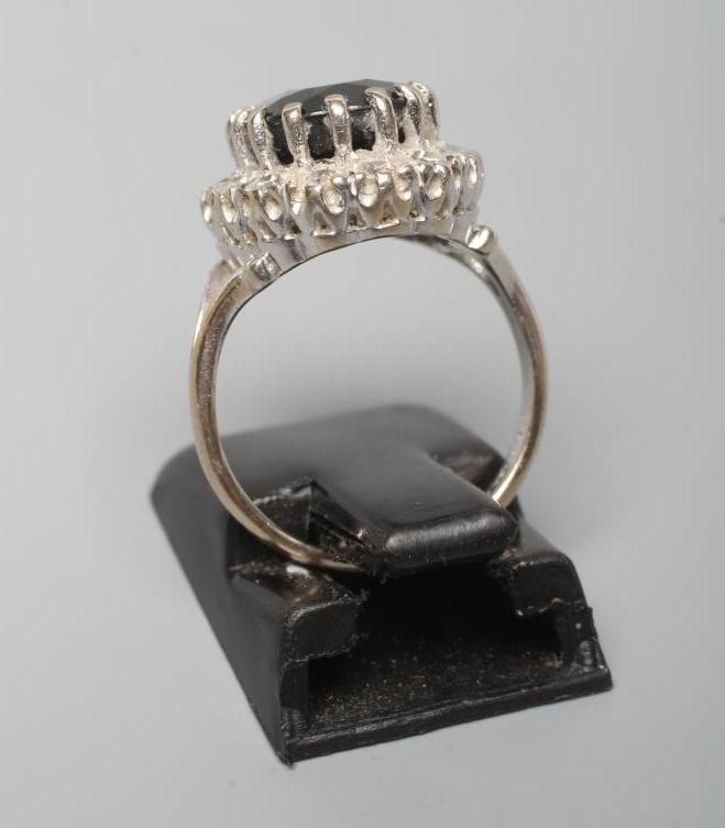 A SAPPHIRE AND DIAMOND CLUSTER RING Image