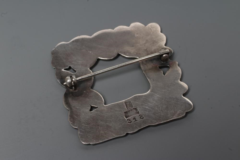 A GEORG JENSEN SILVER SQUARE BROOCH designed by Arno Malinowski, cast as a recumbent deer and Image