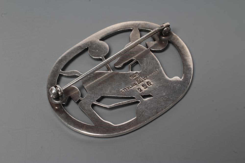 A GEORG JENSEN SILVER OVAL BROOCH designed by Arno Malinowski, cast as a kneeling deer, stamped and Image