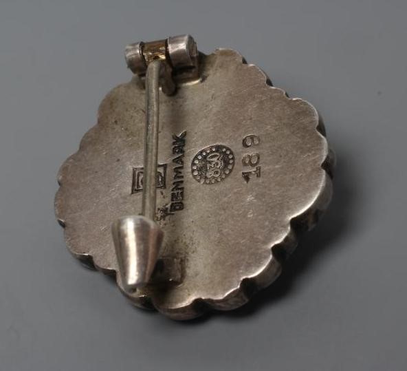 A GEORG JENSEN HOLLOW SILVER FLOWERHEAD BROOCH with polished red hardstone centre, stamped and Image