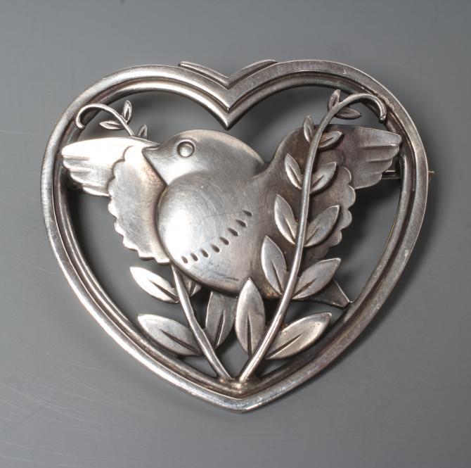 A GEORG JENSEN SILVER HEART SHAPED BROOCH designed by Arno Malinowski with a dove and olive branch, Image