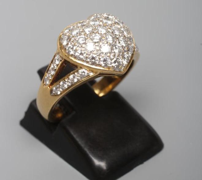 A DIAMOND DRESS RING, the heart shaped panel point set with numerous small stones to open diamond Image