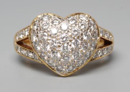 A DIAMOND DRESS RING, the heart shaped panel point set with numerous small stones to open diamond Image