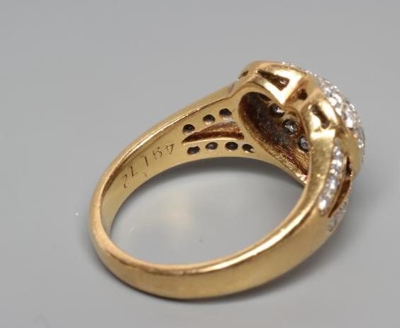 A DIAMOND DRESS RING, the heart shaped panel point set with numerous small stones to open diamond Image