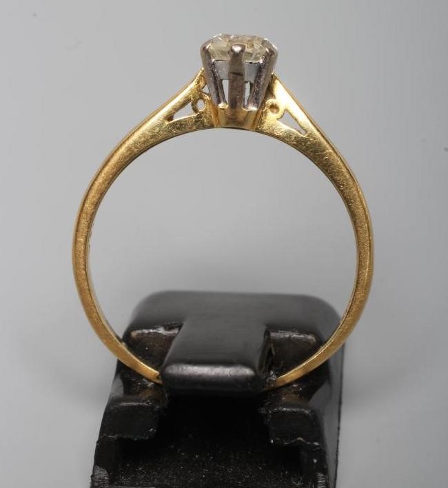 A SOLITAIRE DIAMOND RING, the round brilliant cut stone of approximately 0.5cts claw set to a plain Image