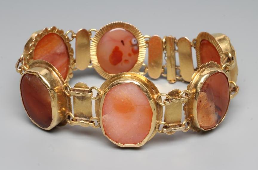 A BRACELET, the six oval polished banded agate panels in rub-over settings with bar links between, Image