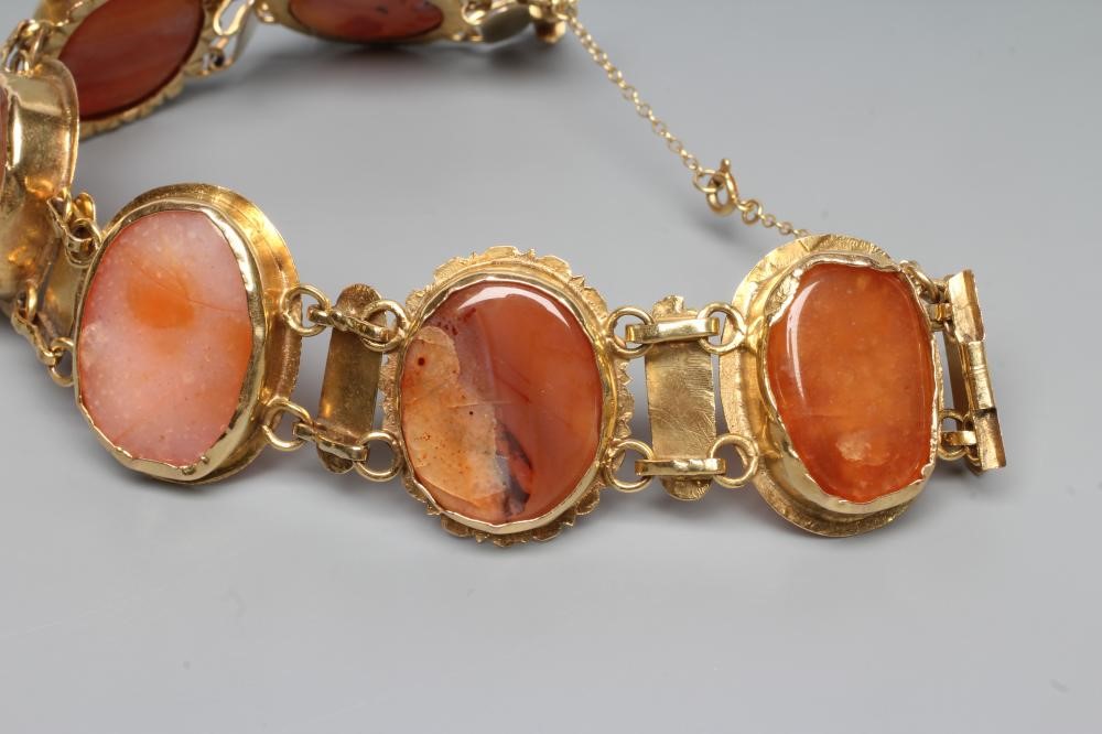 A BRACELET, the six oval polished banded agate panels in rub-over settings with bar links between, Image