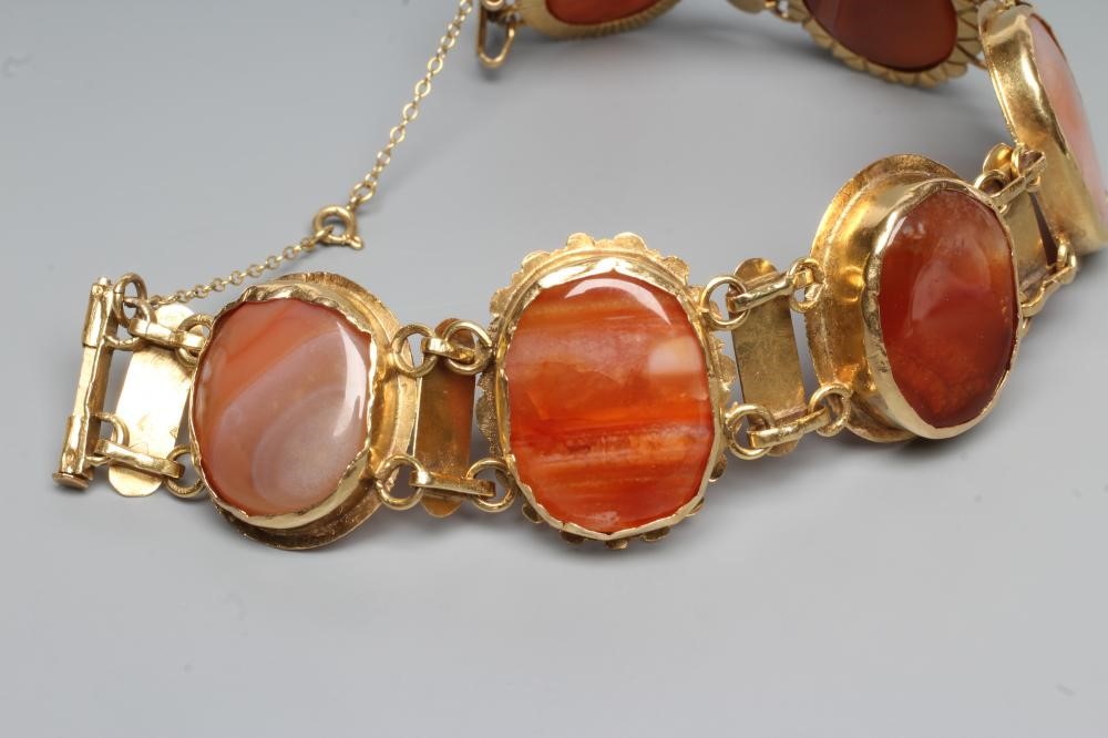 A BRACELET, the six oval polished banded agate panels in rub-over settings with bar links between, Image