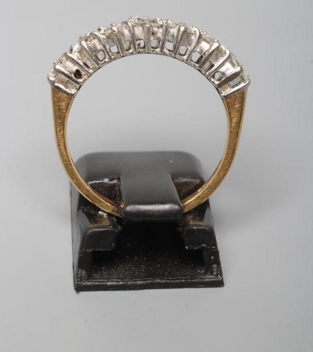 A SEVEN STONE DIAMOND HALF HOOP ETERNITY RING, the round brilliant cut stones claw set to a plain Image