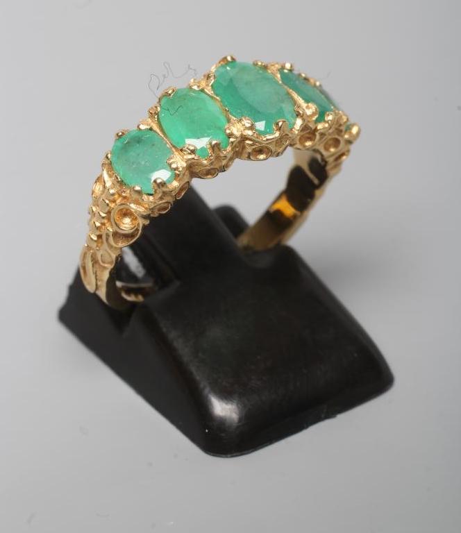 A FIVE STONE EMERALD RING Image