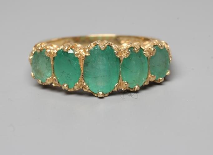 A FIVE STONE EMERALD RING Image