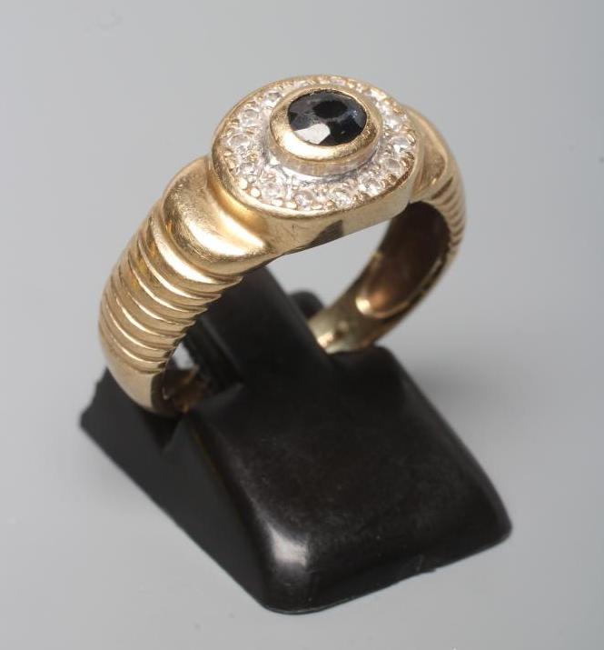 A GENTLEMAN'S SAPPHIRE AND DIAMOND CLUSTER RING Image