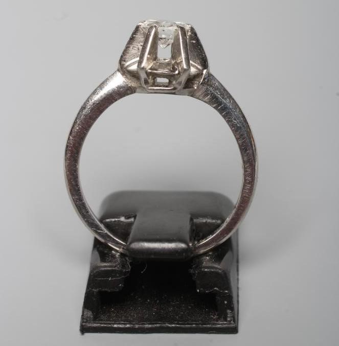 A SOLITAIRE DIAMOND RING, the round brilliant cut stone of approximately 0.7cts in a high claw Image