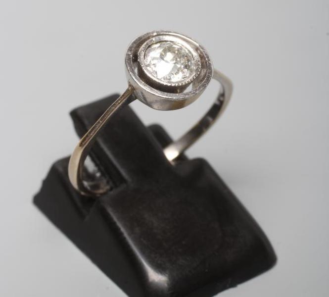 A SOLITAIRE DIAMOND RING, the round brilliant cut stone of approximtely 0.5cts, collet set to a Image