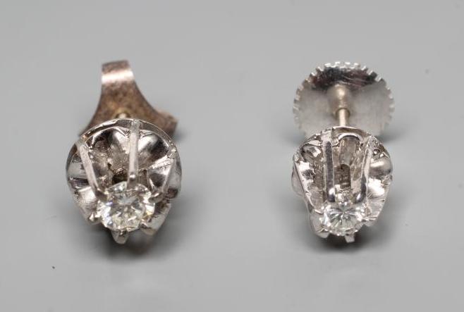 A PAIR OF SOLITAIRE DIAMOND EAR STUDS Image