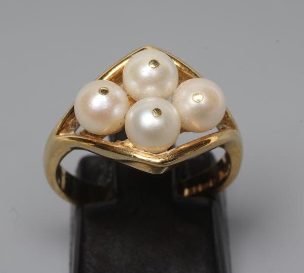 A PEARL DRESS RING, the four cultured pearls "show peg" set to an open lozenge panel and plain 18ct Image