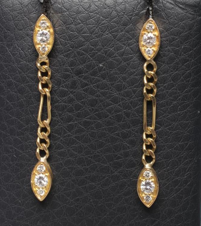 A PAIR OF DIAMOND DROP EAR STUDS, the eliptical panel pave set with three small stones hung with a Image