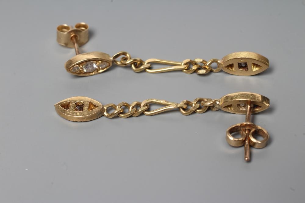 A PAIR OF DIAMOND DROP EAR STUDS, the eliptical panel pave set with three small stones hung with a Image