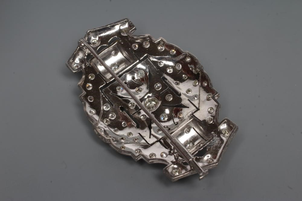 A DIAMOND OVAL OPEN PANEL BROOCH, the central open back collet set stone of approximately 0.35cts Image