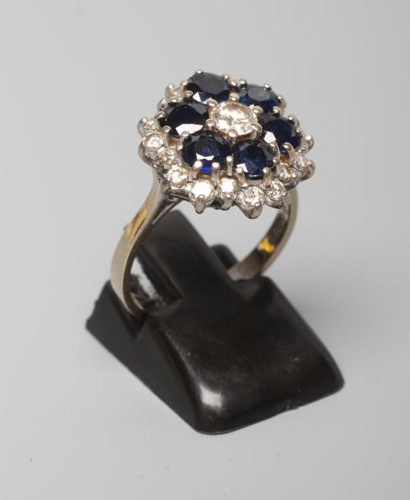 A SAPPHIRE AND DIAMOND CLUSTER RING Image
