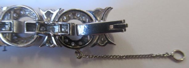 A DIAMOND BRACELET, the central cluster with bow shoulders and open circular links and invisible Image