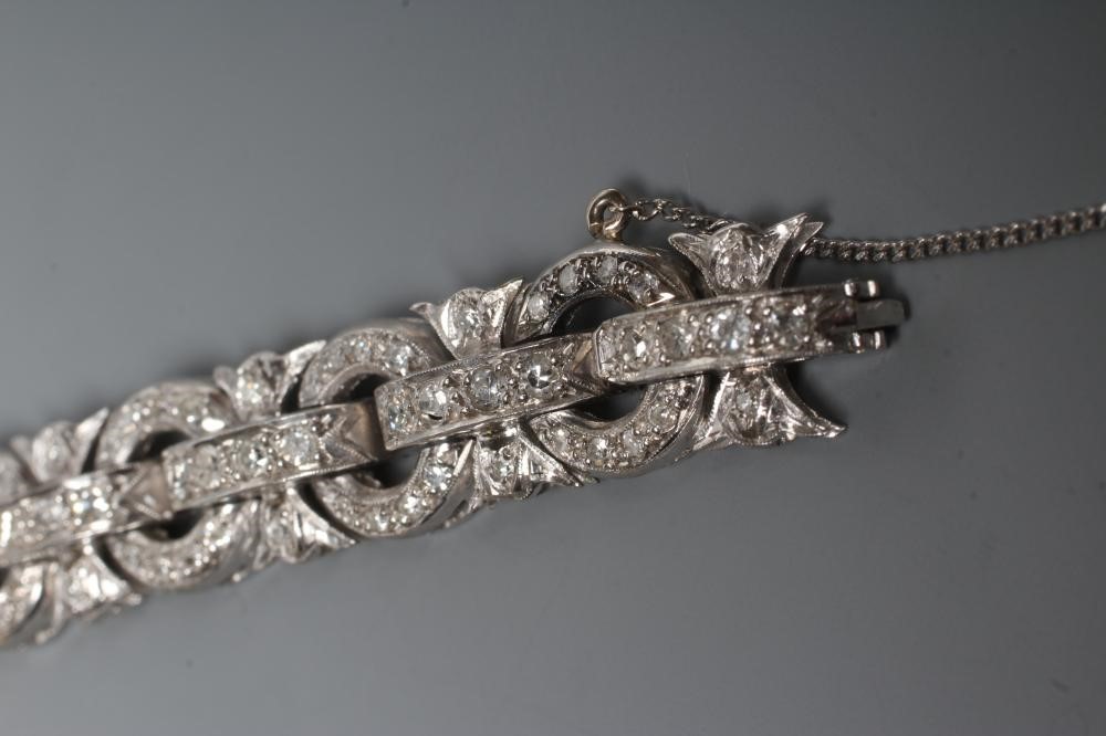A DIAMOND BRACELET, the central cluster with bow shoulders and open circular links and invisible Image