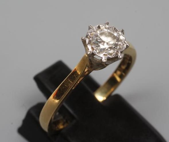 A SOLITAIRE DIAMOND RING, the round brilliant cut stone of 0.31cts illusion set to a plain 18ct gold Image