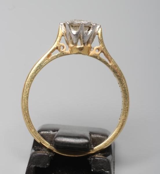 A SOLITAIRE DIAMOND RING, the round brilliant cut stone of 0.31cts illusion set to a plain 18ct gold Image