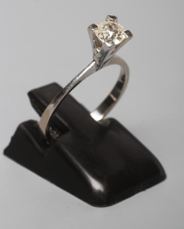 A SOLITAIRE DIAMOND RING, the round brilliant cut stone of approximately 0.30cts claw set to a plain Image
