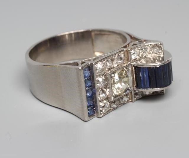 AN ART DECO STYLE SAPPHIRE AND DIAMOND "BUCKLE" COCKTAIL RING Image