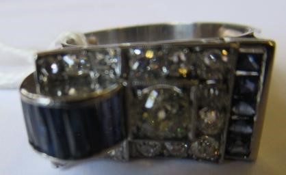 AN ART DECO STYLE SAPPHIRE AND DIAMOND "BUCKLE" COCKTAIL RING Image