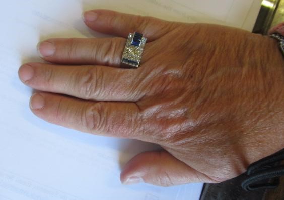 AN ART DECO STYLE SAPPHIRE AND DIAMOND "BUCKLE" COCKTAIL RING Image