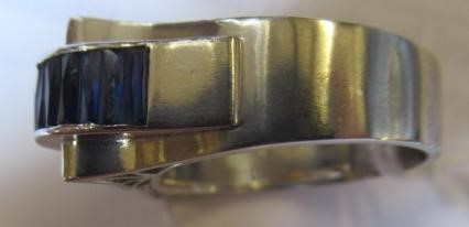 AN ART DECO STYLE SAPPHIRE AND DIAMOND "BUCKLE" COCKTAIL RING Image